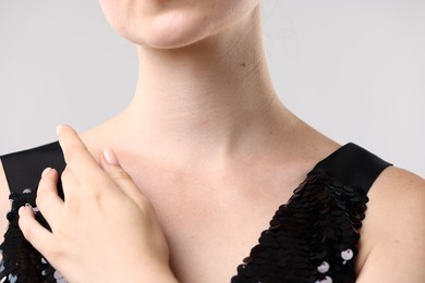 Photo of Closeup view of woman on light grey background