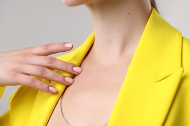 Photo of Closeup view of woman on grey background