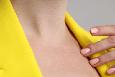 Photo of Closeup view of woman on grey background
