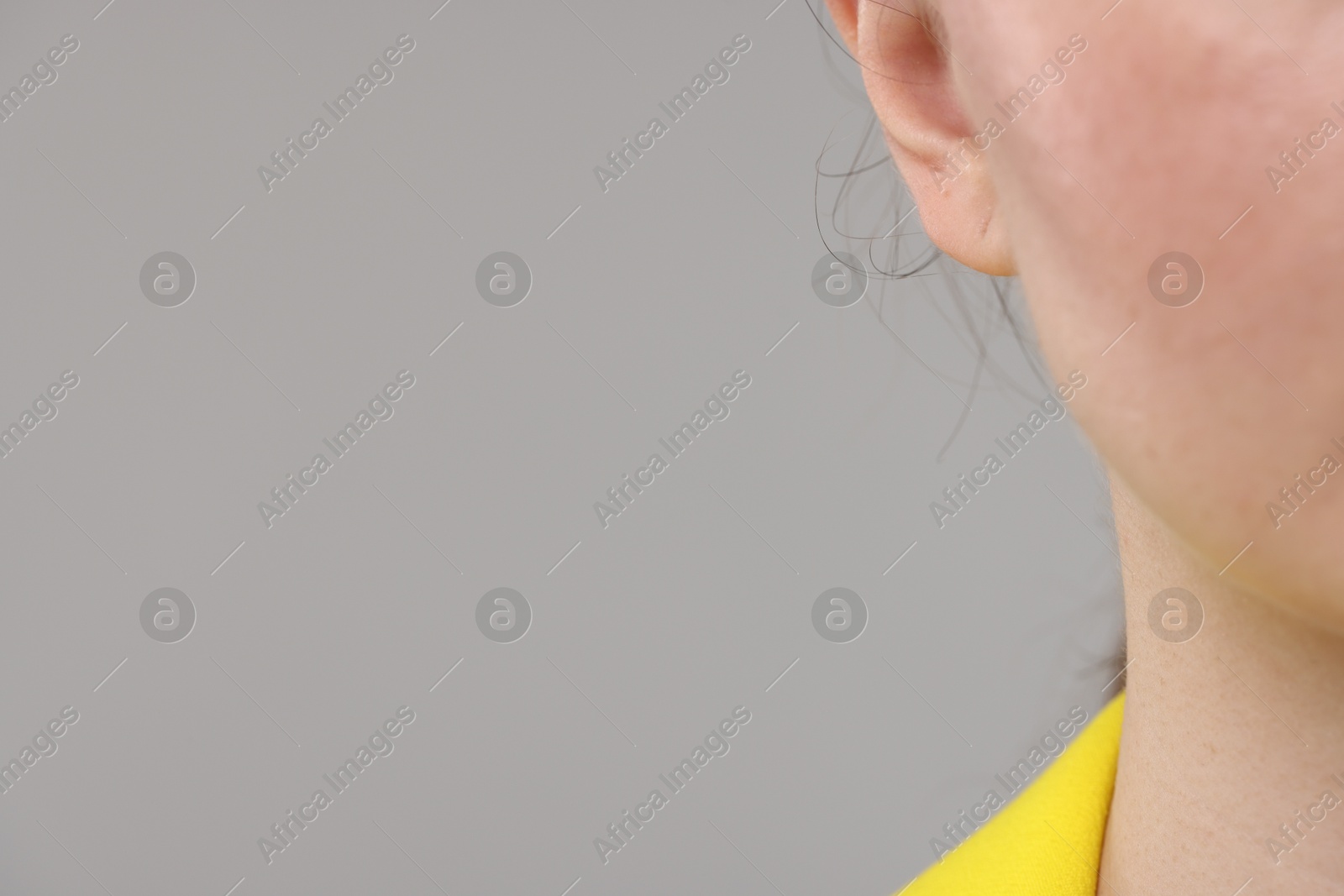 Photo of Woman on grey background, closeup. Space for text