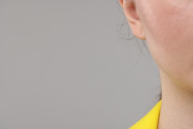 Photo of Woman on grey background, closeup. Space for text