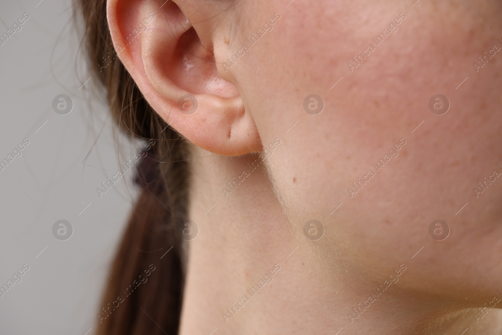 Photo of Closeup view of woman on grey background