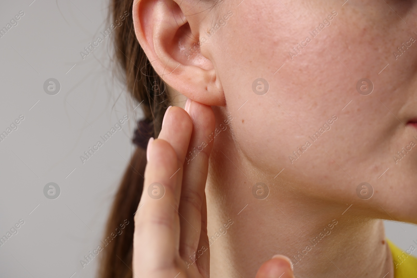 Photo of Closeup view of woman on grey background