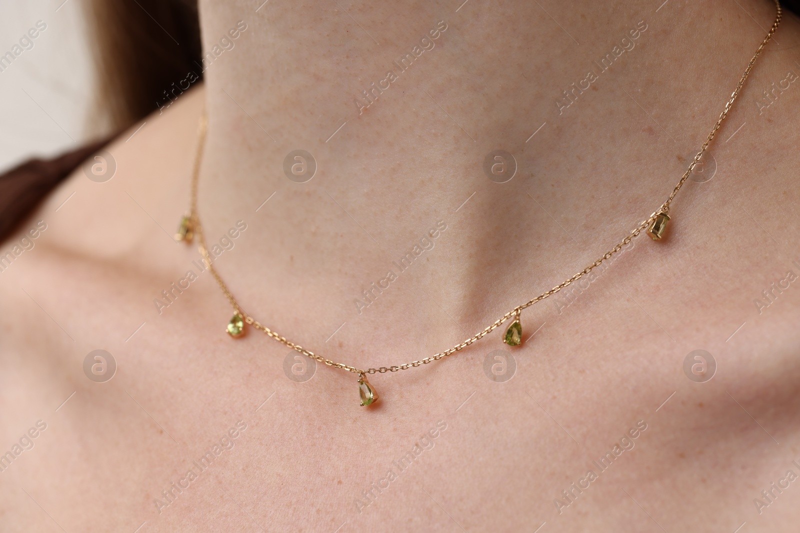 Photo of Woman wearing stylish necklace on light grey background, closeup