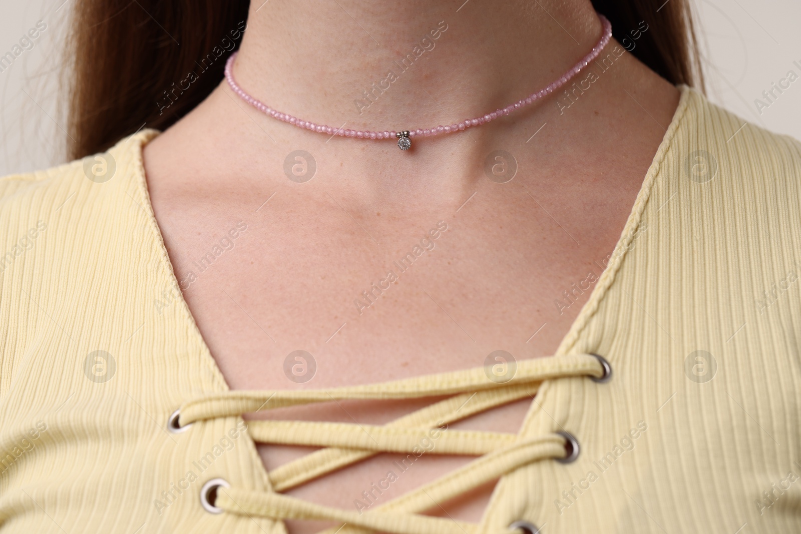 Photo of Woman wearing stylish pink necklace, closeup view