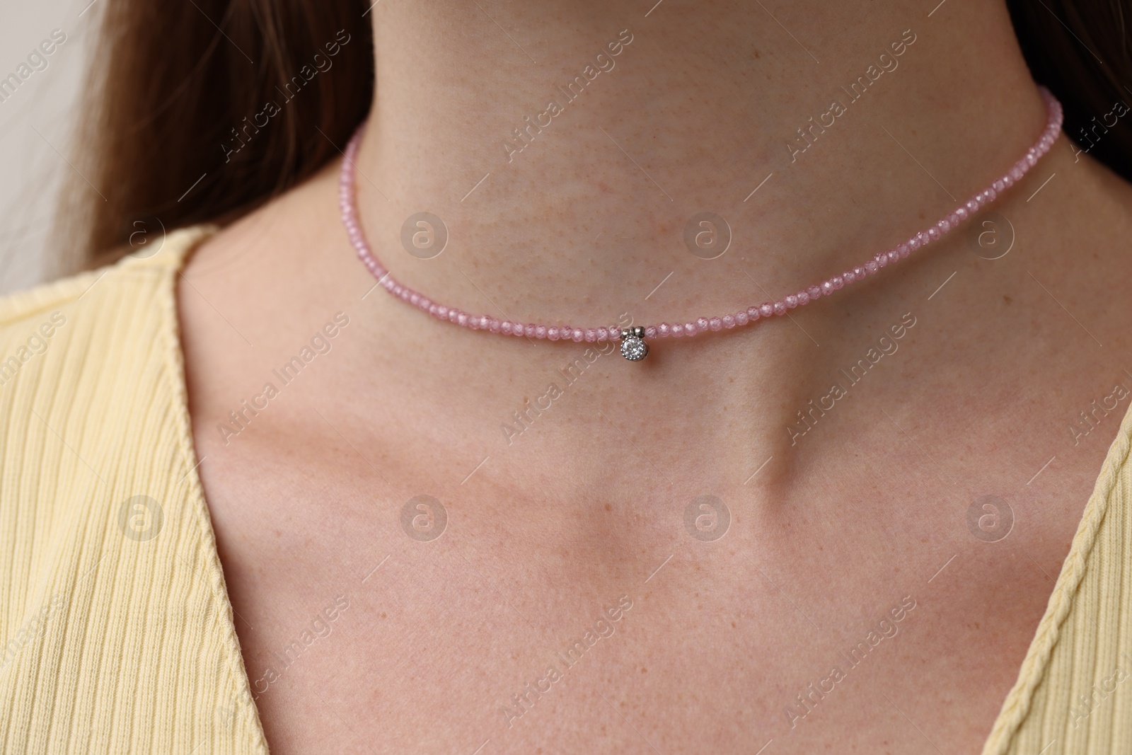 Photo of Woman wearing stylish pink necklace, closeup view