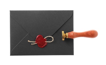 Photo of Wax stamp and black envelope with seal isolated on white, top view