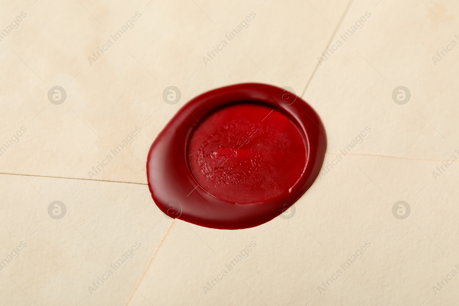 Beautiful envelope with red wax seal as background, closeup Photo of Beautiful envelope with red wax seal as background, closeup