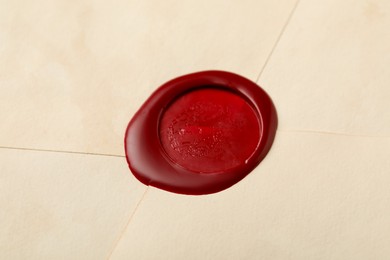 Photo of Beautiful envelope with red wax seal as background, closeup