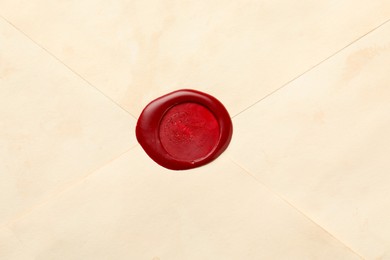 Photo of Beautiful envelope with red wax seal as background, top view