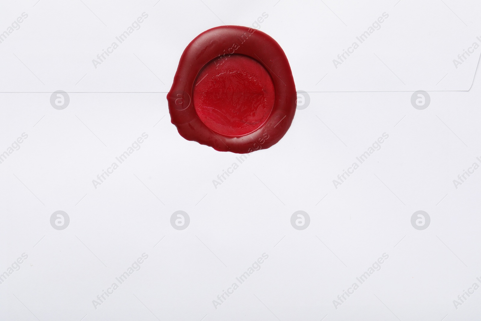 Beautiful envelope with red wax seal as background, top view Photo of Beautiful envelope with red wax seal as background, top view