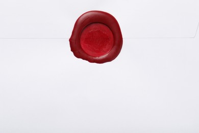 Photo of Beautiful envelope with red wax seal as background, top view