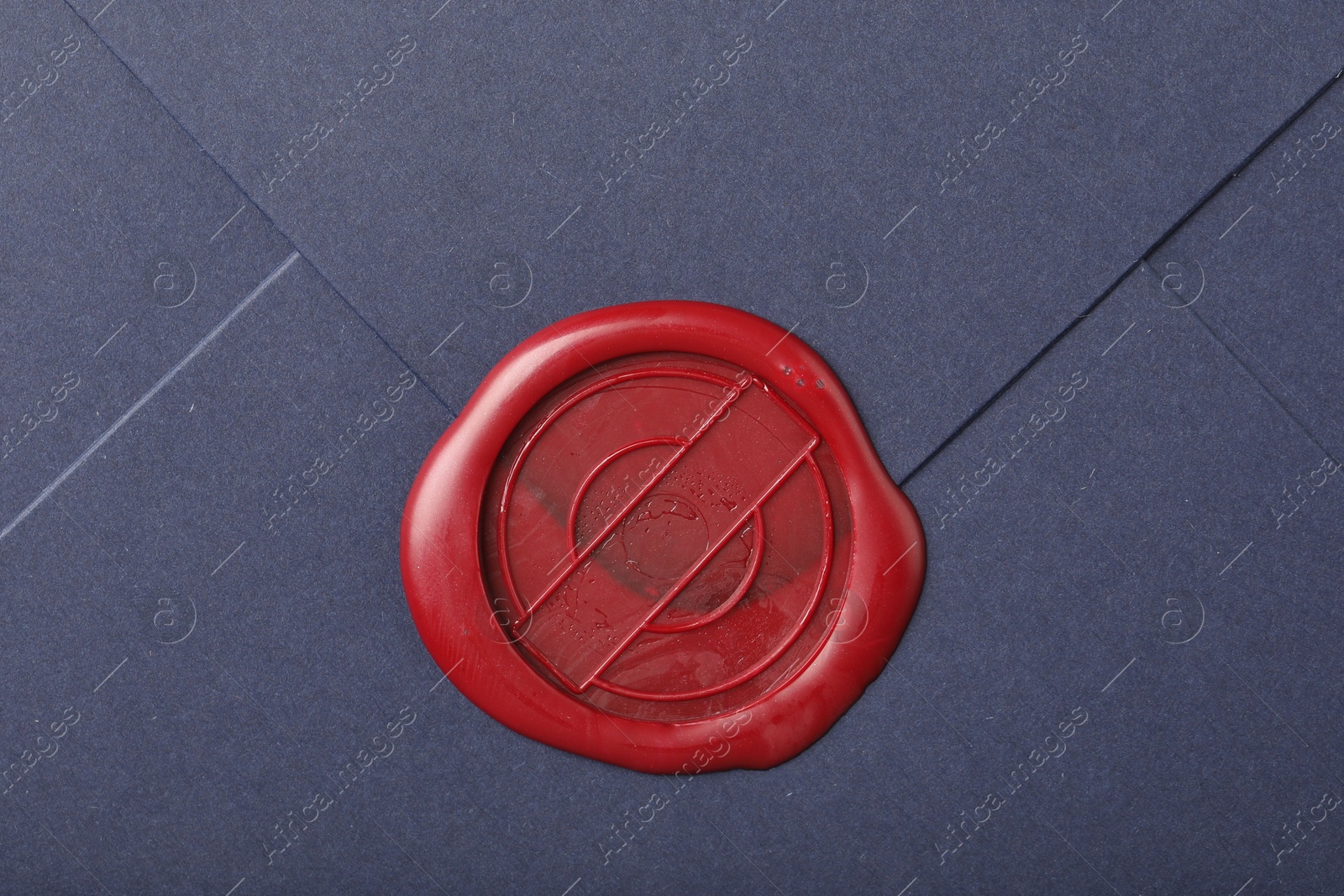 Beautiful envelope with red wax seal as background, top view Photo of Beautiful envelope with red wax seal as background, top view