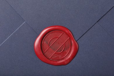 Photo of Beautiful envelope with red wax seal as background, top view