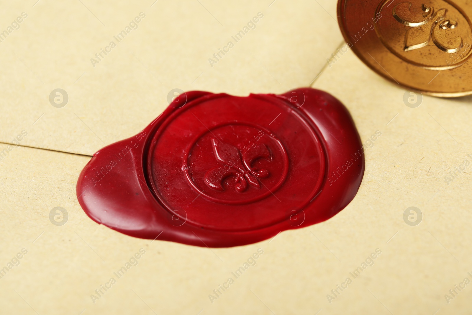 Beautiful envelope with red wax seal and stamp, closeup Photo of Beautiful envelope with red wax seal and stamp, closeup