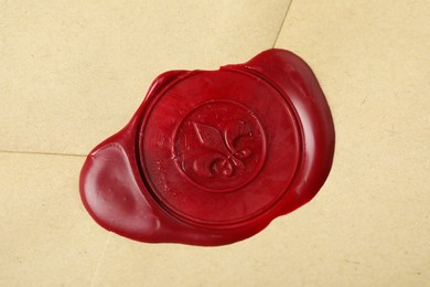 Photo of Beautiful envelope with red wax seal as background, top view
