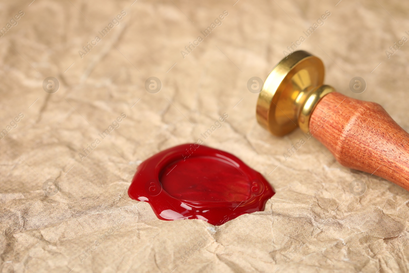 Beautiful wax stamp and red seal on crumpled paper, closeup Photo of Beautiful wax stamp and red seal on crumpled paper, closeup
