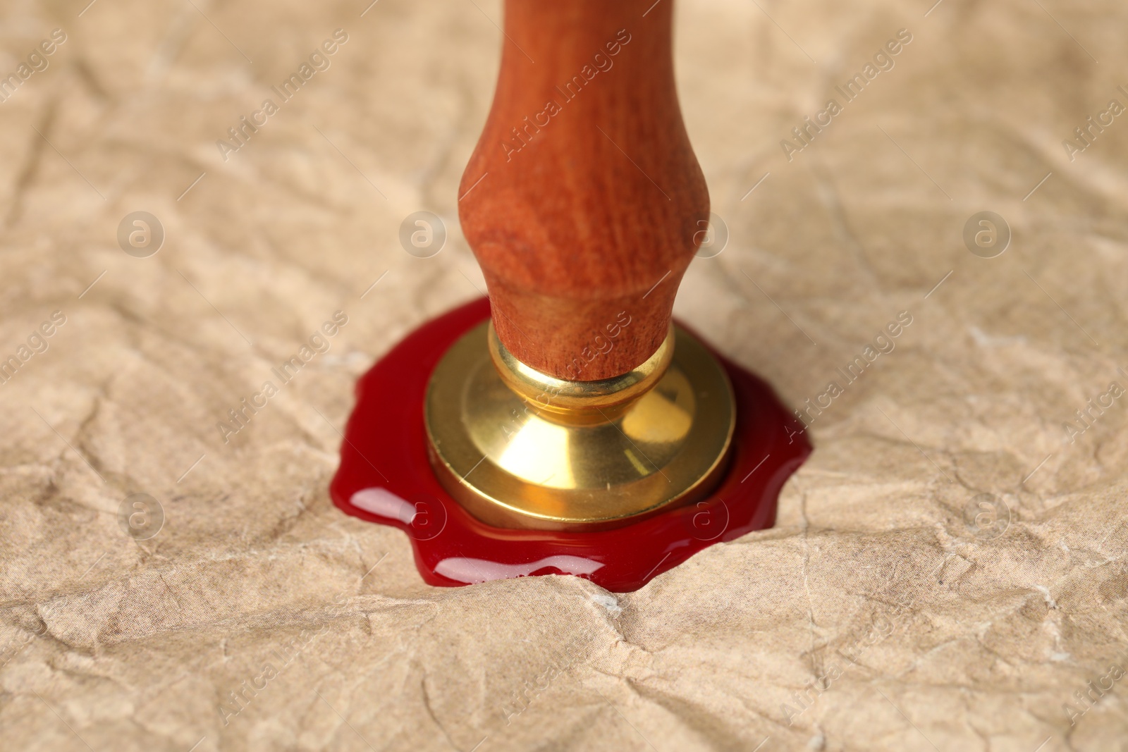 Sealing crumpled paper with wax stamp, closeup Photo of Sealing crumpled paper with wax stamp, closeup