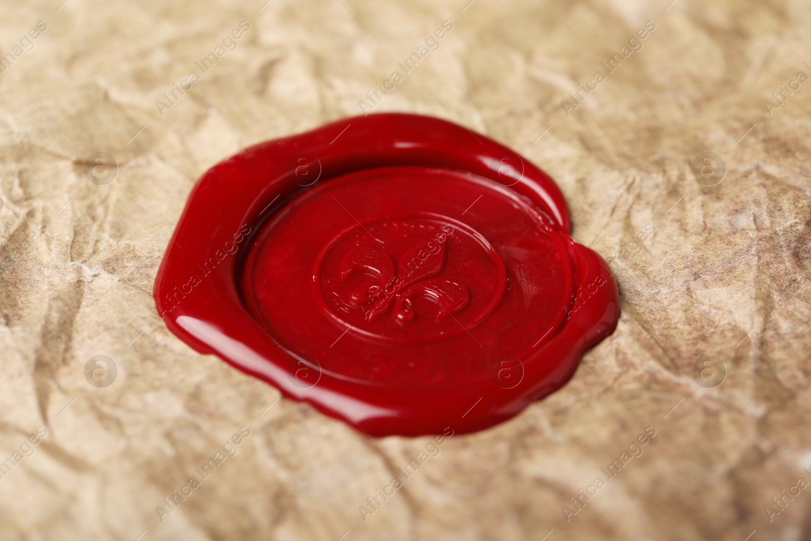 Red wax seal on crumpled paper, closeup Photo of Red wax seal on crumpled paper, closeup