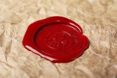 Photo of Red wax seal on crumpled paper, closeup