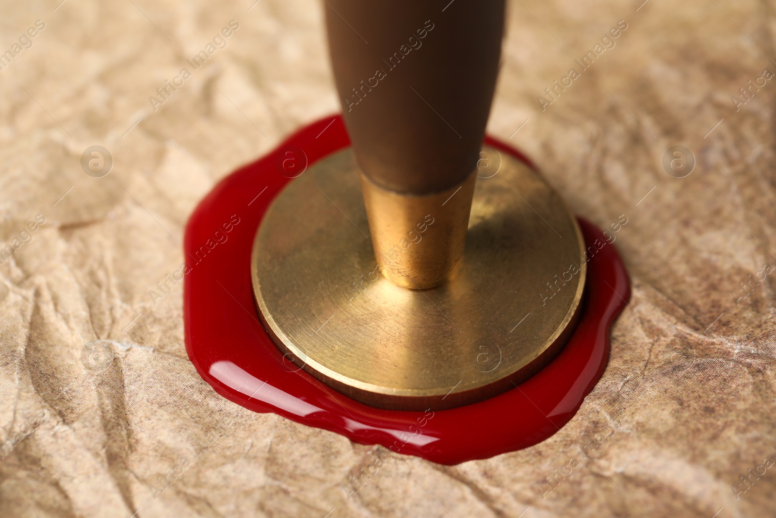 Sealing crumpled paper with wax stamp, closeup Photo of Sealing crumpled paper with wax stamp, closeup