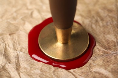 Photo of Sealing crumpled paper with wax stamp, closeup
