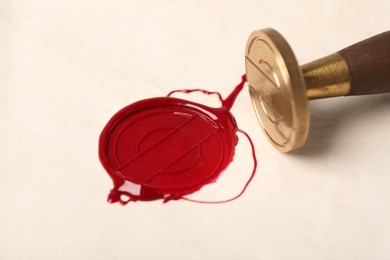 Photo of Beautiful wax stamp and red seal on paper, closeup