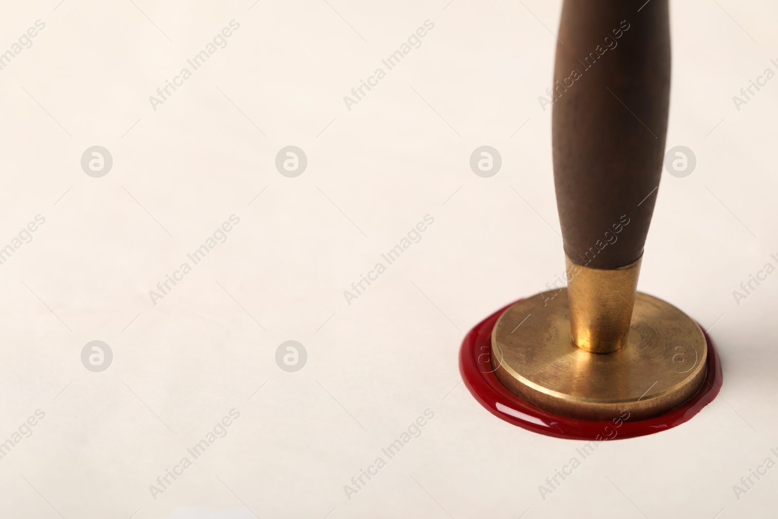 Sealing white paper with wax stamp, closeup. Space for text Photo of Sealing white paper with wax stamp, closeup. Space for text