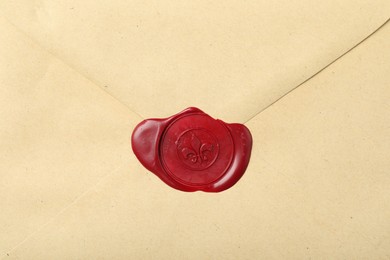 Photo of Beautiful envelope with red wax seal as background, top view