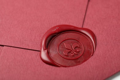 Photo of Beautiful envelope with red wax seal as background, closeup