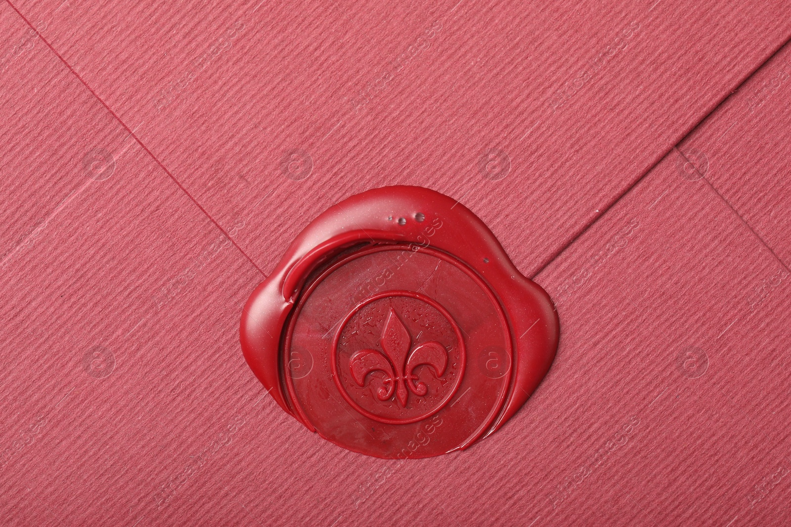 Beautiful envelope with red wax seal as background, top view Photo of Beautiful envelope with red wax seal as background, top view