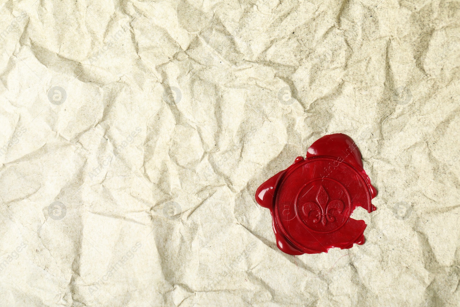 Red wax seal on crumpled paper, top view. Space for text Photo of Red wax seal on crumpled paper, top view. Space for text
