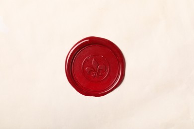 Photo of Red wax seal on light paper, top view