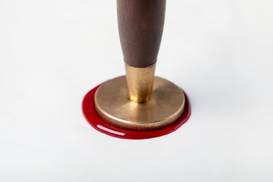 Photo of Sealing white paper with wax stamp, closeup