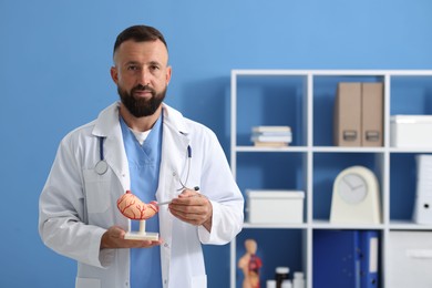Photo of Gastroenterologist with model of stomach in clinic