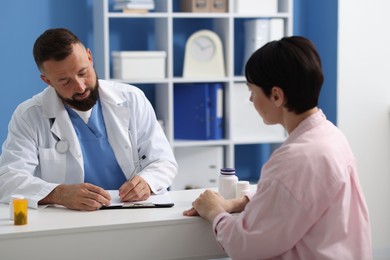 Photo of Woman having appointment with gastroenterologist in clinic