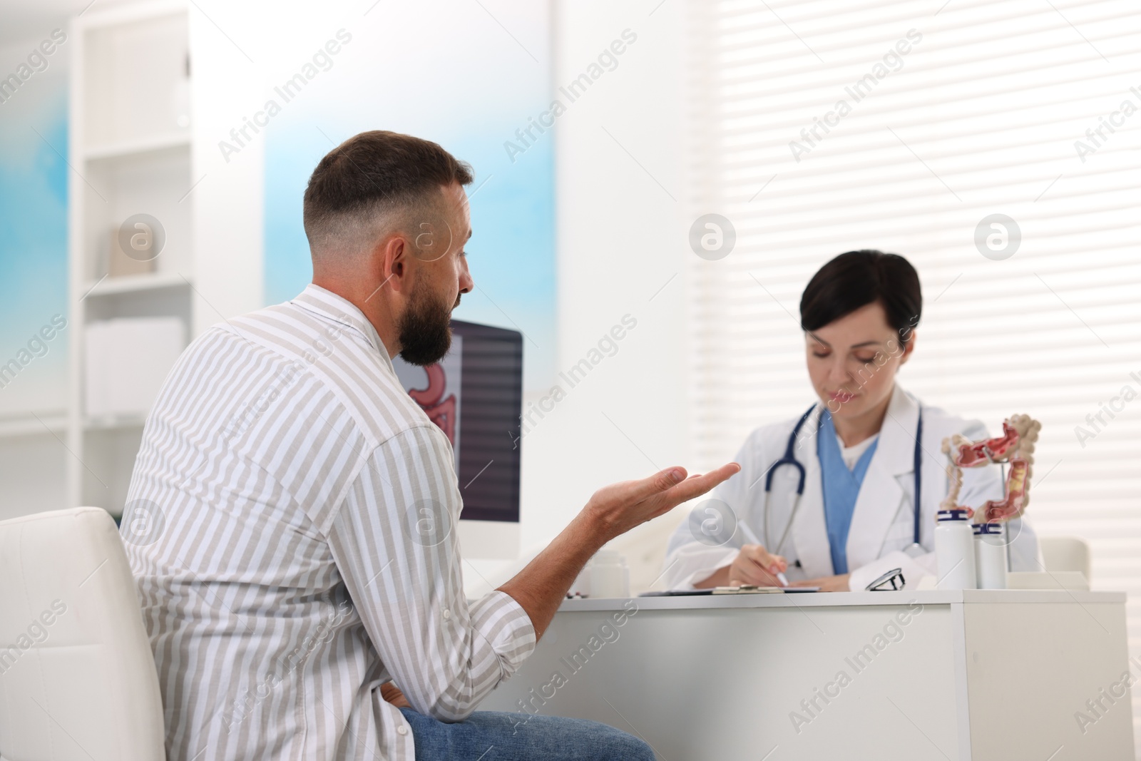 Photo of Man having appointment with gastroenterologist in clinic