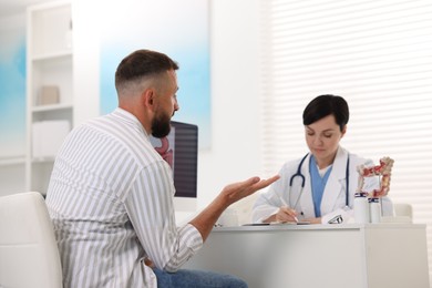 Photo of Man having appointment with gastroenterologist in clinic