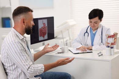 Photo of Man having appointment with gastroenterologist in clinic