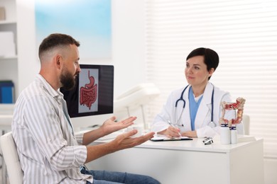 Photo of Man having appointment with gastroenterologist in clinic