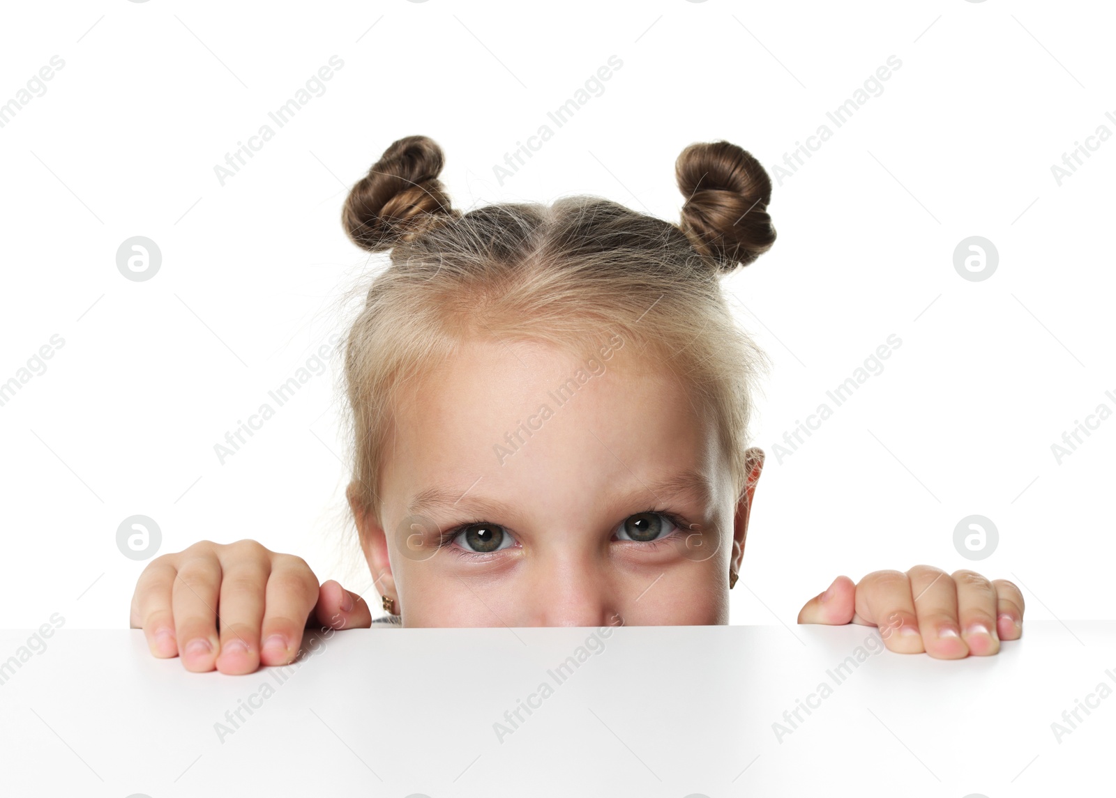 Photo of Curious little girl peeking over table against white background