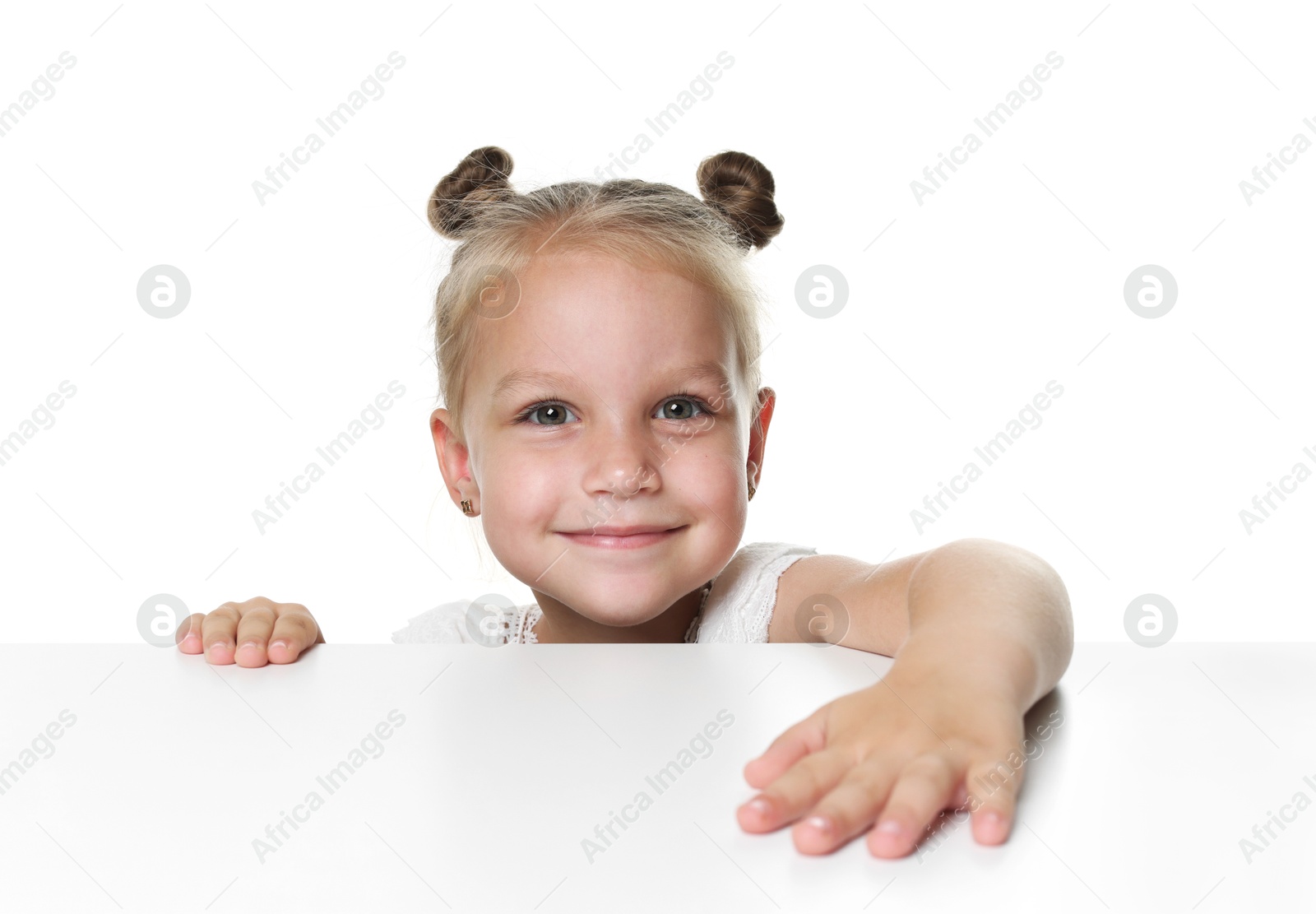 Photo of Curious little girl peeking over table against white background