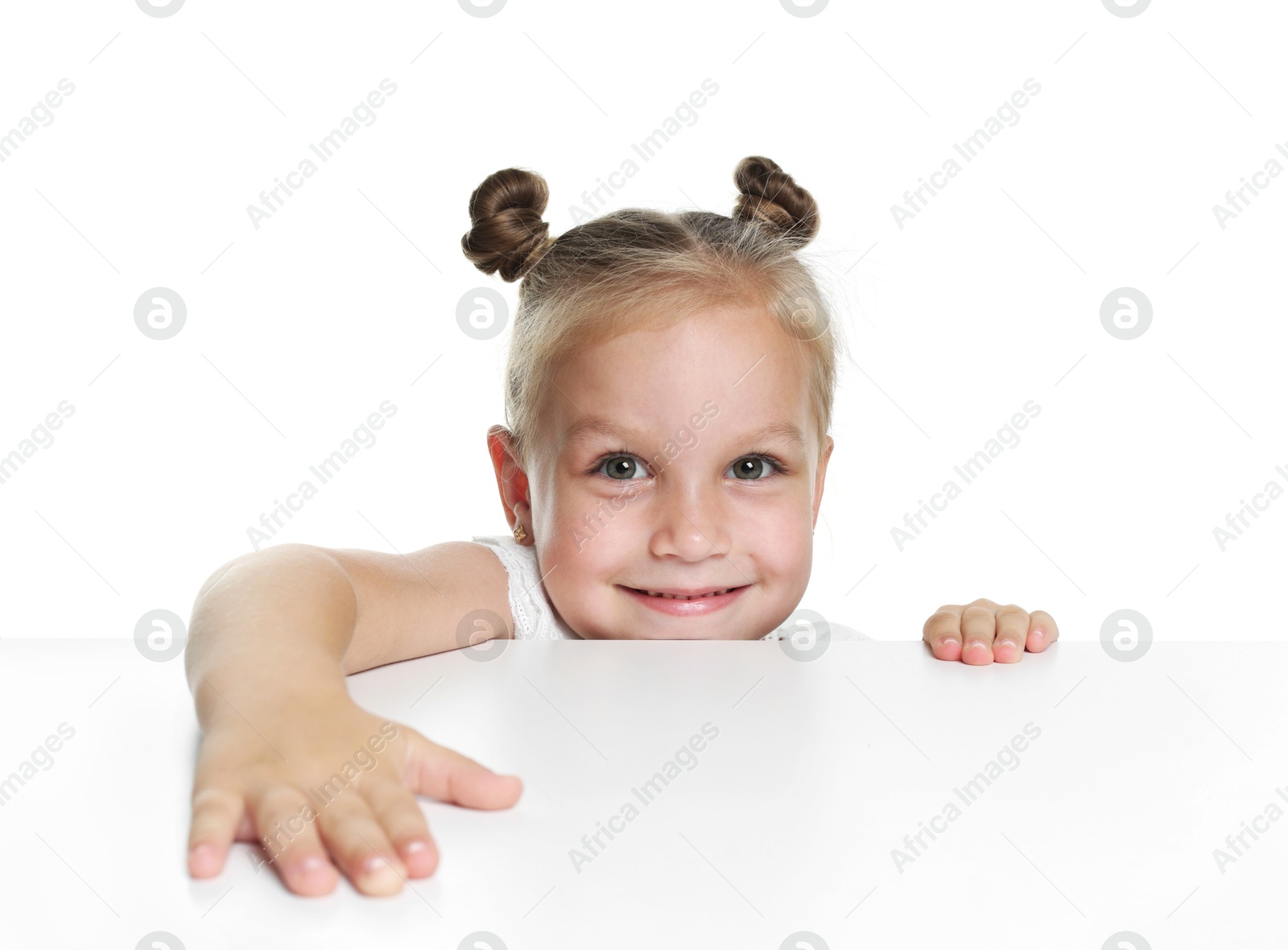 Photo of Curious little girl peeking over table against white background