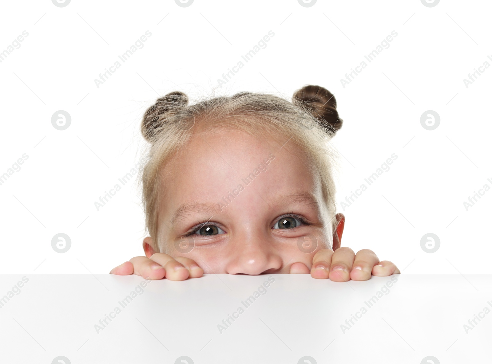 Photo of Curious little girl peeking over table against white background
