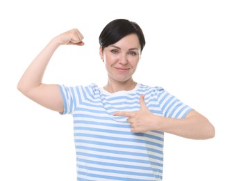Photo of Strength. Beautiful woman pointing at her biceps on white background