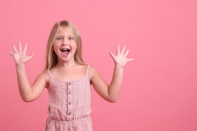 Photo of Cute little girl laughing on pink background. Space for text
