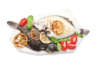 Photo of Tasty roasted flounder fish with tomatoes, basil and lemon slices isolated on white, top view. Homemade seafood dish