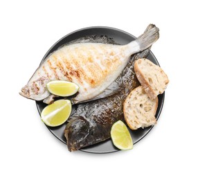 Photo of Tasty roasted flounder fish with bread and lime slices isolated on white, top view. Homemade seafood dish