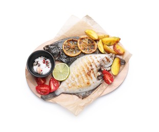 Photo of Tasty roasted flounder fish with potatoes, tomatoes and lemon slices isolated on white, top view. Homemade seafood dish