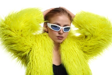 Photo of Beautiful woman in stylish sunglasses and fur coat posing on white background